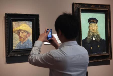 A visitor at the Detroit Institute of Arts museum uses his cell phone to take a picture of the 'Self Portrait' painting by painter Vincent van Gogh in Detroit, Michigan June 2, 2013. Picture taken June 2, 2013. REUTERS/Rebecca Cook