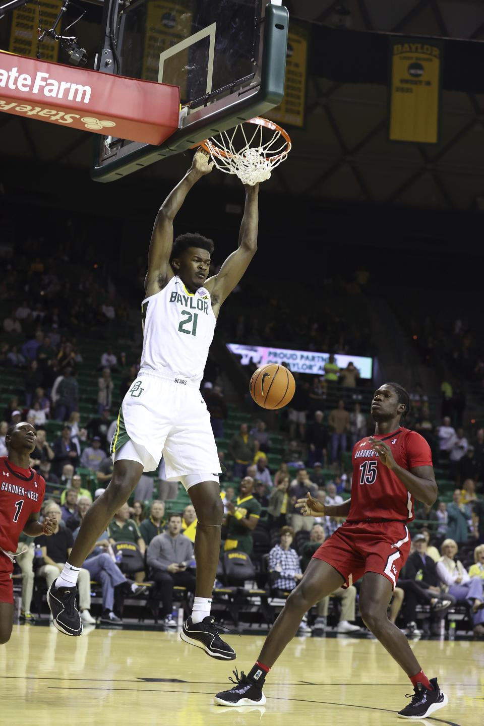 Baylor center Yves Missi (21) dunks past Gardner-Webb forward Cheickna Sissoko (15) in the first half of an NCAA college basketball game, Sunday, Nov. 12, 2023, in Waco, Texas. (AP Photo/Jerry Larson)