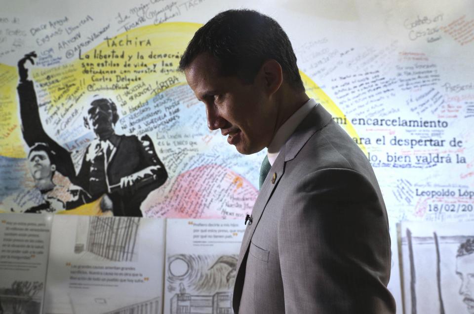 Venezuela's opposition leader Juan Guaidó, who declared himself the interim-president of Venezuela, stands next to a mural at the Popular Will party's headquarters, in Caracas, Venezuela, Friday, May 10, 2019. In an interview Friday with The Associated Press, Guaidó repeated his willingness to consider inviting foreign troops to force Nicolas Maduro from power, echoing the line from Washington that “all options” are on the table for dealing with Venezuela’s rapidly-escalating crisis. (AP Photo/Martin Mejia)