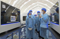 Hong Kong Chief Executive Carrie Lam, left, tours the temporary air-inflated laboratory after a ceremony to welcome the arrival of the Mainland Chinese nucleic acid test support team at Sun Yat Sen Memorial Park Sports Centre in Hong Kong, Friday, Aug. 28, 2020. Hong Kong authorities are preparing for the start of controversial universal community testing program to detect as many cases of the coronavirus as possible. (Hong Kong Government Information Services via AP)