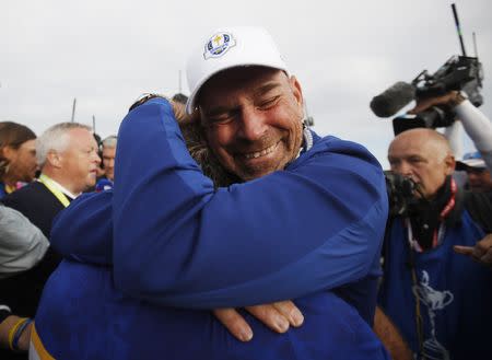 Golf - 2018 Ryder Cup at Le Golf National - Guyancourt, France - September 30, 2018. Team Europe's Francesco Molinari celebrates with captain Thomas Bjorn after winning the Ryder Cup REUTERS/Carl Recine
