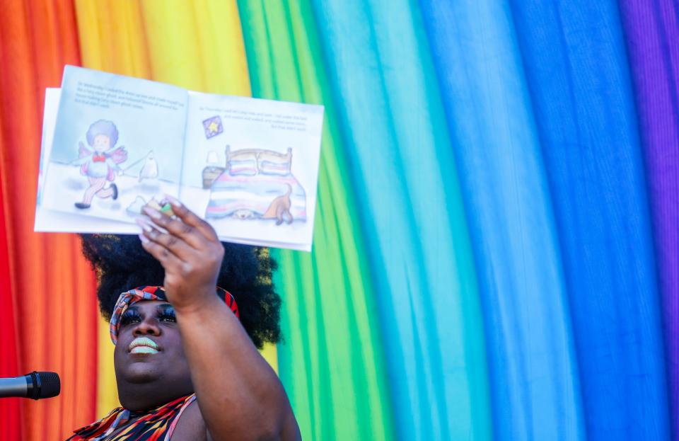 Drag performer Diana Ray held up a book while reading to children at the Reading With Pride event in the Portland neighborhood. March 26, 2023 