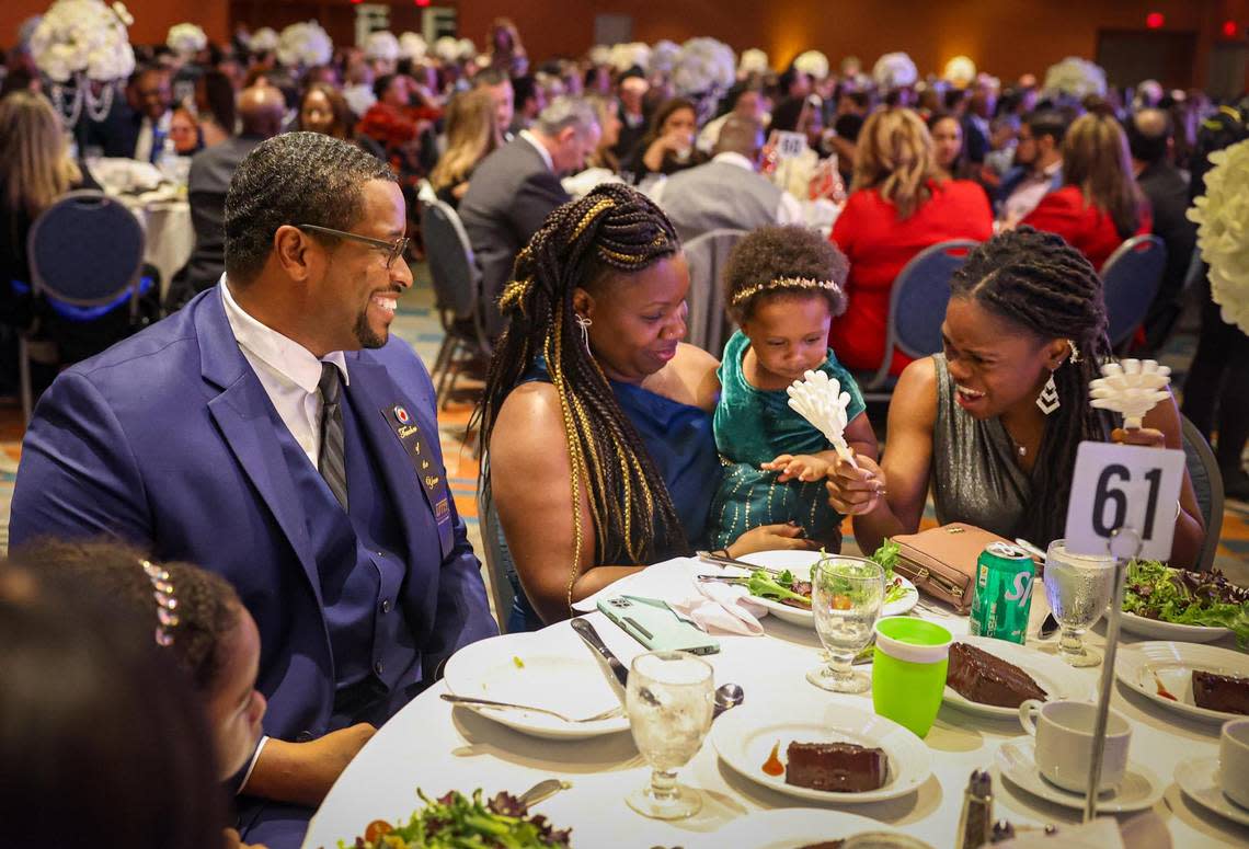 Don Clerveaux, a science and social studies teacher at Phyllis Ruth Miller Elementary, left, sits with his wife Carmen and their daughter Corrine, 1, and Clerveaux’s sister, Vivencia. Clerveaux was named the 2024 Francisco R. Walker Teacher of the Year for Miami-Dade County Public Schools during a ceremony on Tuesday, Jan. 31, 2023.
