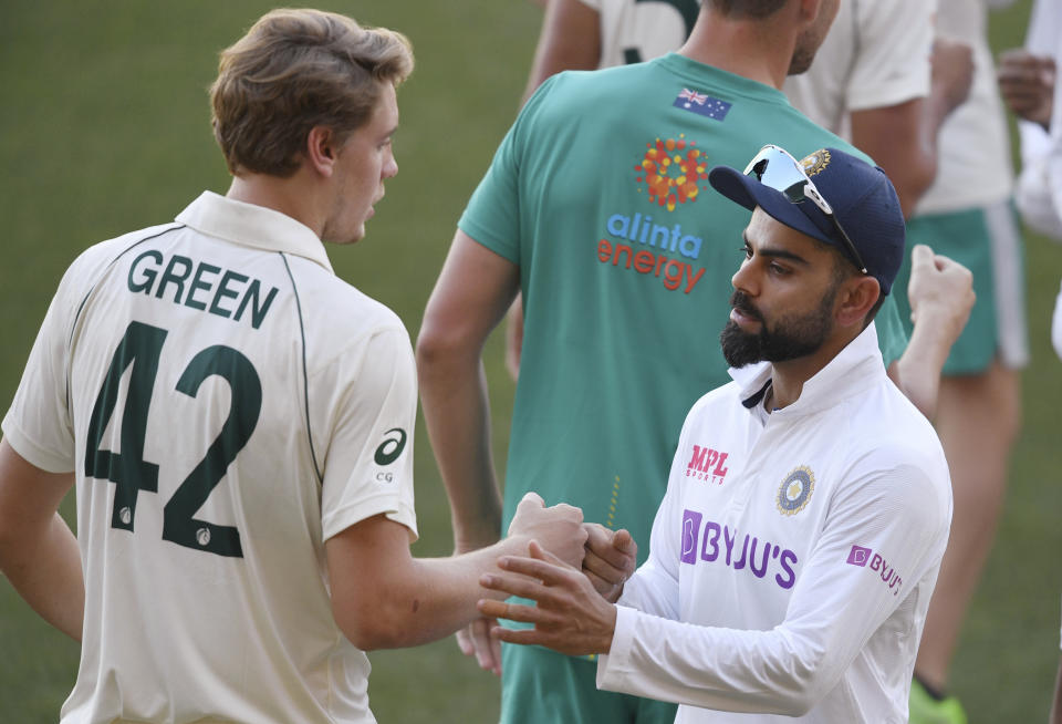 India's Virat Kohli, right, shakes hands with Australia's Cameron Green after Australia won on the third day of their cricket test match at the Adelaide Oval in Adelaide, Australia, Saturday, Dec. 19, 2020. Australia won the match. (AP Photo/David Mariuz)
