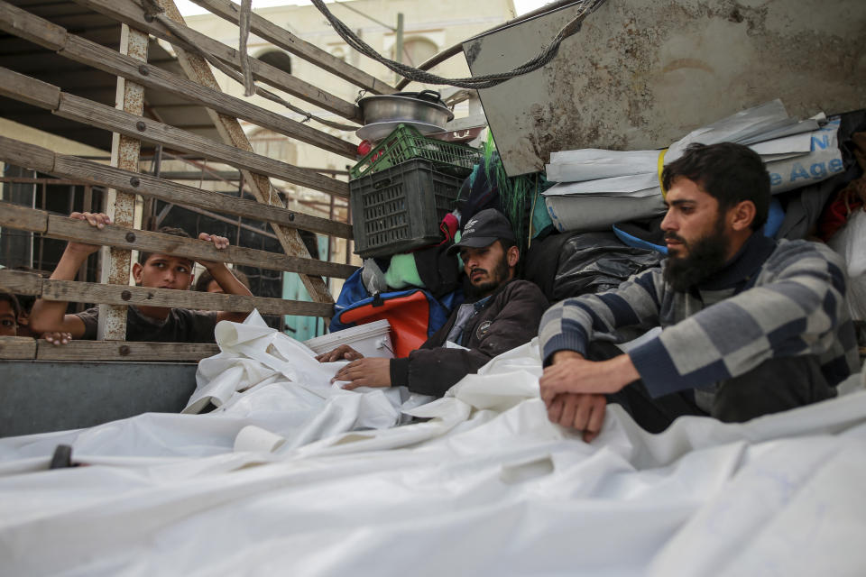 Palestinians mourn over the bodies of relatives killed in an Israeli airstrike, at a morgue in Rafah, Gaza Strip, Monday, May 27, 2024. Palestinian health workers said Israeli airstrikes Sunday killed at least 35 people sheltering in a tent camp for displaced people. Israel's army confirmed the strike and said it hit a Hamas installation and killed two senior Hamas militants. (AP Photo/Jehad Alshrafi)