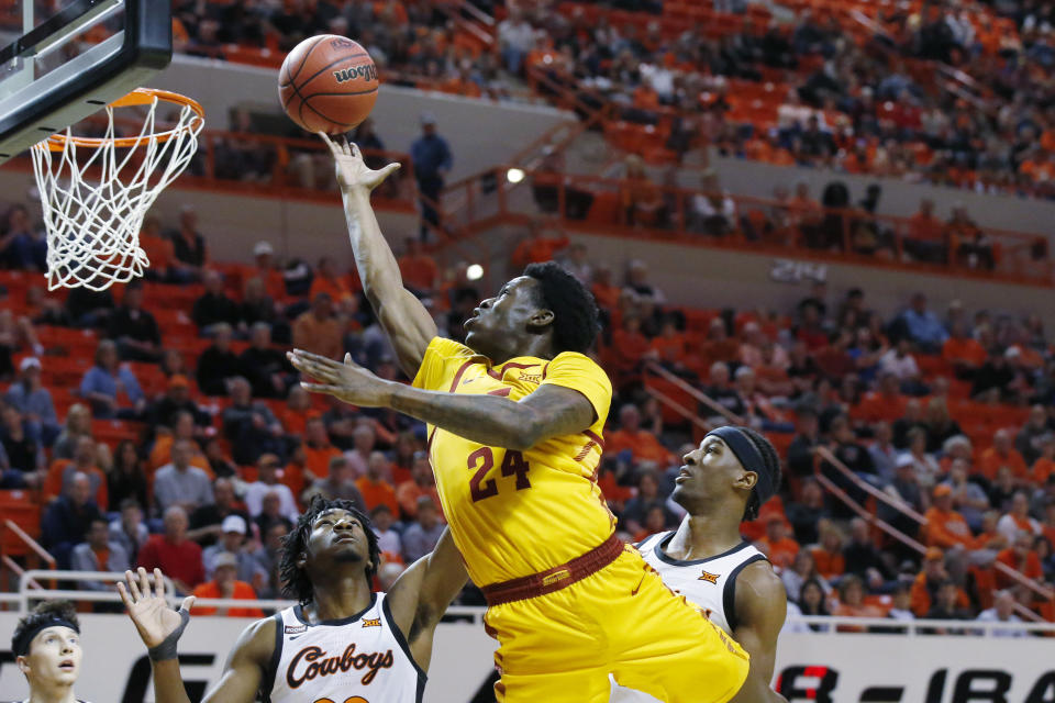 Iowa State guard Terrence Lewis (24) shoots in front of Oklahoma State forward Kalib Boone, left, and forward Cameron McGriff, right, in the second half of an NCAA college basketball game in Stillwater, Okla., Saturday, Feb. 29, 2020. (AP Photo/Sue Ogrocki)
