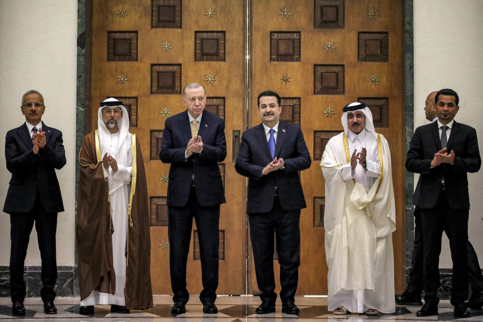 From left, Turkey's Transport Minister Abdulkadir Uraloglu, UAE's Energy Minister Suhail Mohamed al-Mazrouei, Turkey's President Recep Tayyip Erdogan, Iraq's Prime Minister Mohammed Shia al-Sudani, Qatar's Minister of Transport Jassim bin Saif bin Ahmed al-Sulaiti, and Iraq's Transport Minister Razzaq Muhaibas al-Saadawi applaud together during their meeting in Baghdad, Iraq, Monday April 22, 2024. (Ahmad Al-Rubaye/Pool via AP)