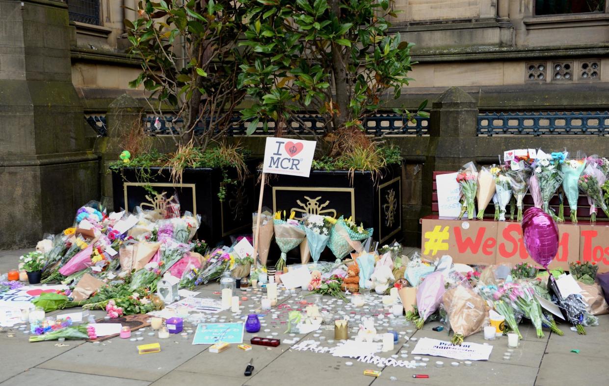 Floral tributes left by Manchester Town Hall after a suicide bomber killed 22 people leaving a pop concert at the Manchester Arena on Monday night: Ben Birchall/PA