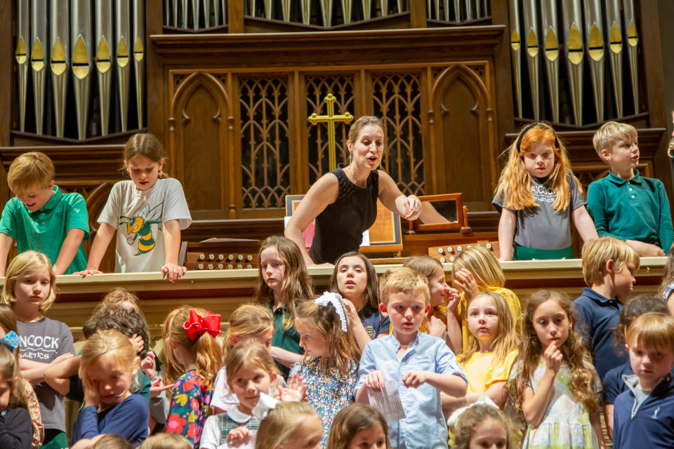 Monica Harper Dekle, director of music at Wesley Monumental UMC, helps 62 1st-5th grade students find their place as they rehearse for the Children of the Light concert, which will be held on February 26 at Wesley Monumental UMC.
