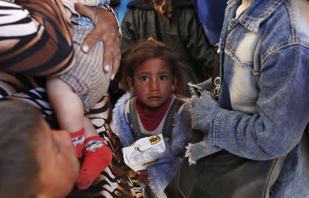 Syrian Kurdish refugee children wait inside a temporary medical facility after crossing into Turkey near the southeastern Turkish town of Suruc in Sanliurfa province October 1, 2014. REUTERS/Murad Sezer