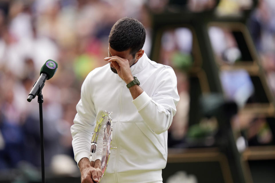 Serbia's Novak Djokovic cries after losing to Spain's Carlos Alcaraz in the men's singles final on day fourteen of the Wimbledon tennis championships in London, Sunday, July 16, 2023. (AP Photo/Alberto Pezzali)