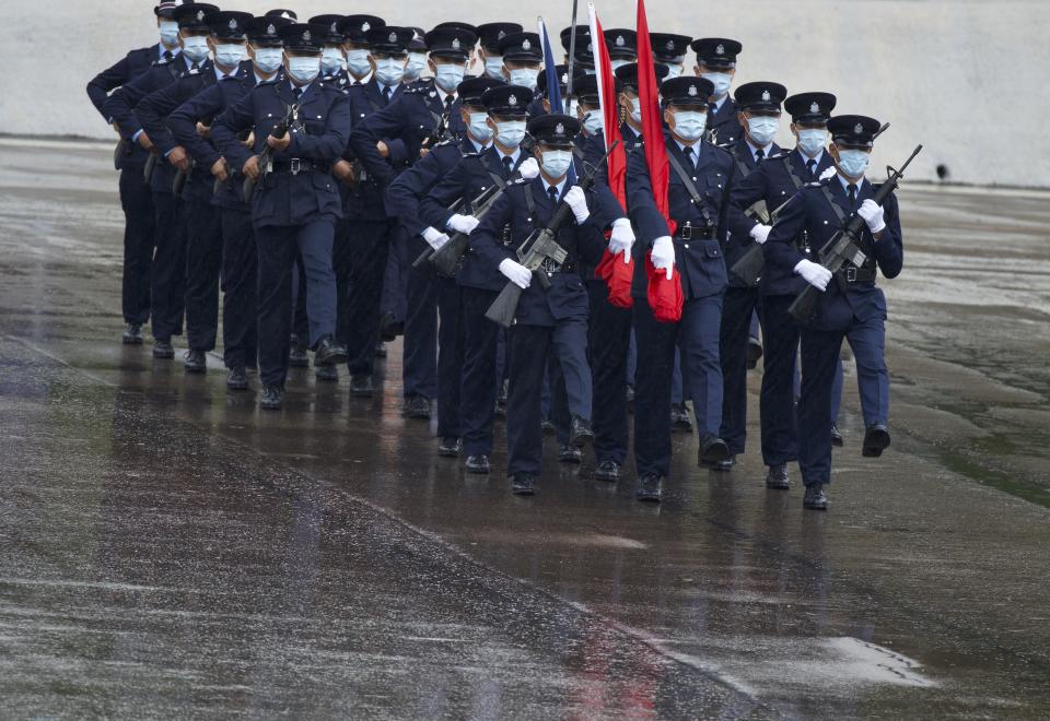 Hong Kong police show their new goose step marching style on the National Security Education Day at a police school in Hong Kong Thursday, April 15, 2021. Authorities in Hong Kong are marking the day with a police college open house, where police personnel demonstrated the Chinese military's "goose step" march, replacing British-style foot drills. The "goose step" march is one in which troops swing their legs off the ground in unison, keeping each leg straight.(AP Photo/Vincent Yu)