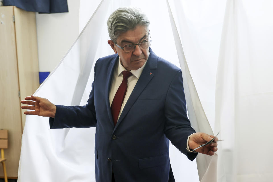 Far left leader Jean-Luc Melenchon exits the voting booth before voting, in Paris, Sunday, June 30, 2024. (AP Photo/Thomas Padilla)