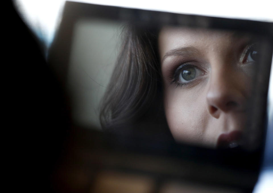 <p>Valerie Brown, of Knoxville, Tenn., works on her makeup during the first round of the New York Jets Flight Crew cheerleader auditions, April 8, 2017, at MetLife Stadium in East Rutherford, N.J. (Photo: Julio Cortez/AP) </p>