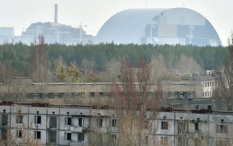 The defunct power station looms over abandoned Pripyat - Credit: GETTY