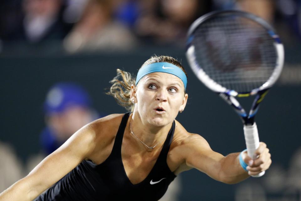 Lucie Safarova, of Czech Republic, returns to Samantha Stosur, of Australia, during their match at the Family Circle Cup tennis tournament in Charleston, S.C., Thursday, April 3, 2014. (AP Photo/Mic Smith)