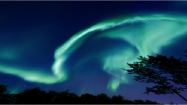 A display of the aurora borealis. Sometimes the Northern Lights appear to dance, but also may just produce a colorful glowing in the sky.