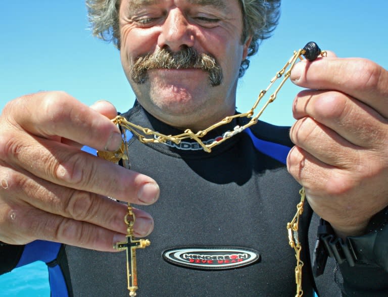 Bill Burt, a diver for Mel Fisher's Treasures, with a centuries-old gold chain with religious pendants he found on March 23, 2011 while searching for the sterncastle of the 17th-century sunken Spanish ship that sank off the Florida Keys in 1622