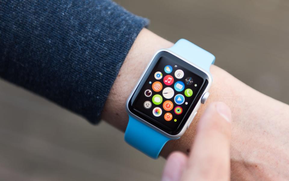 SEATTLE, USA - May 9, 2015: Man Using App on Apple Watch While Outside. Multiple Apps View.