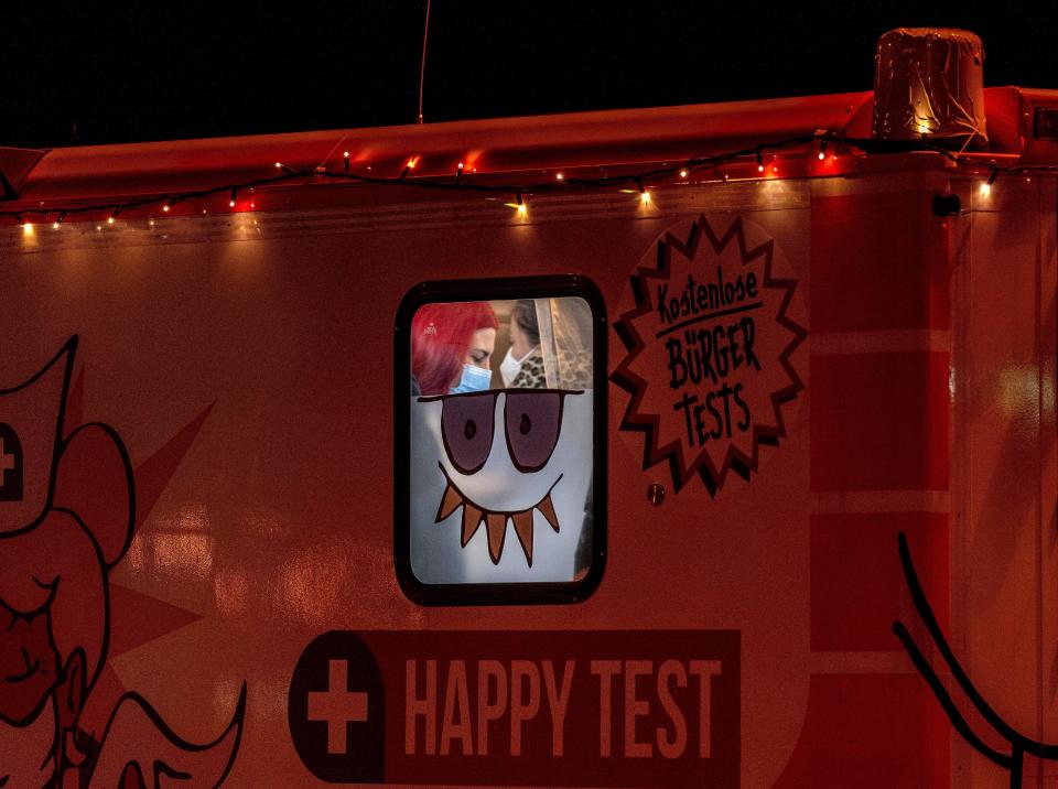Medical workers wait for customers in a mobile test station test in Frankfurt, Germany, Monday, Jan. 24, 2022, when German politician discuss further measures to avoid a new spread of the coronavirus. (AP Photo/Michael Probst)