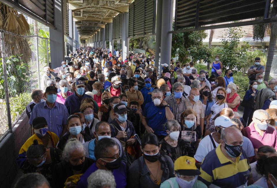 FILE - In this Sept 16, 2021, file photo, residents gather outside a vaccination center looking to be inoculated with a second dose of the Sputnik V COVID-19 vaccine, in Caracas, Venezuela. Millions from Latin America to the Middle East are waiting for promised doses of the Russian-made Sputnik V coronavirus vaccine due to manufacturing problems and other issues. Venezuela ordered 10 million doses in December 2020 but has only gotten slightly over 3 million. (AP Photo/Ariana Cubillos, File)