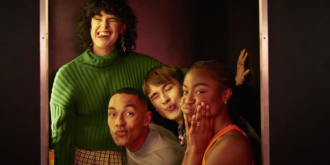 portrait of female and male friends making faces inside photo booth