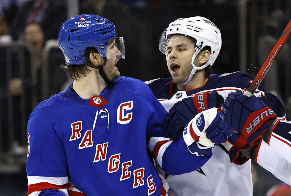 Columbus Blue Jackets center Adam Fantilli (11) talks to New York Rangers defenseman Jacob Trouba (8) after a scuffle during the first period of an NHL hockey game, Sunday, Nov. 12, 2023, in New York. (AP Photo/Noah K. Murray)