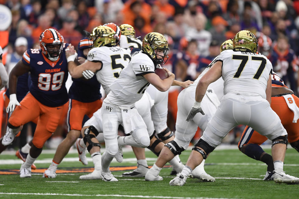 Wake Forest quarterback Michael Kern (15) runs with the ball during the first half of an NCAA college football game against Syracuse in Syracuse, N.Y., Saturday, Nov. 25, 2023. (AP Photo/Adrian Kraus)