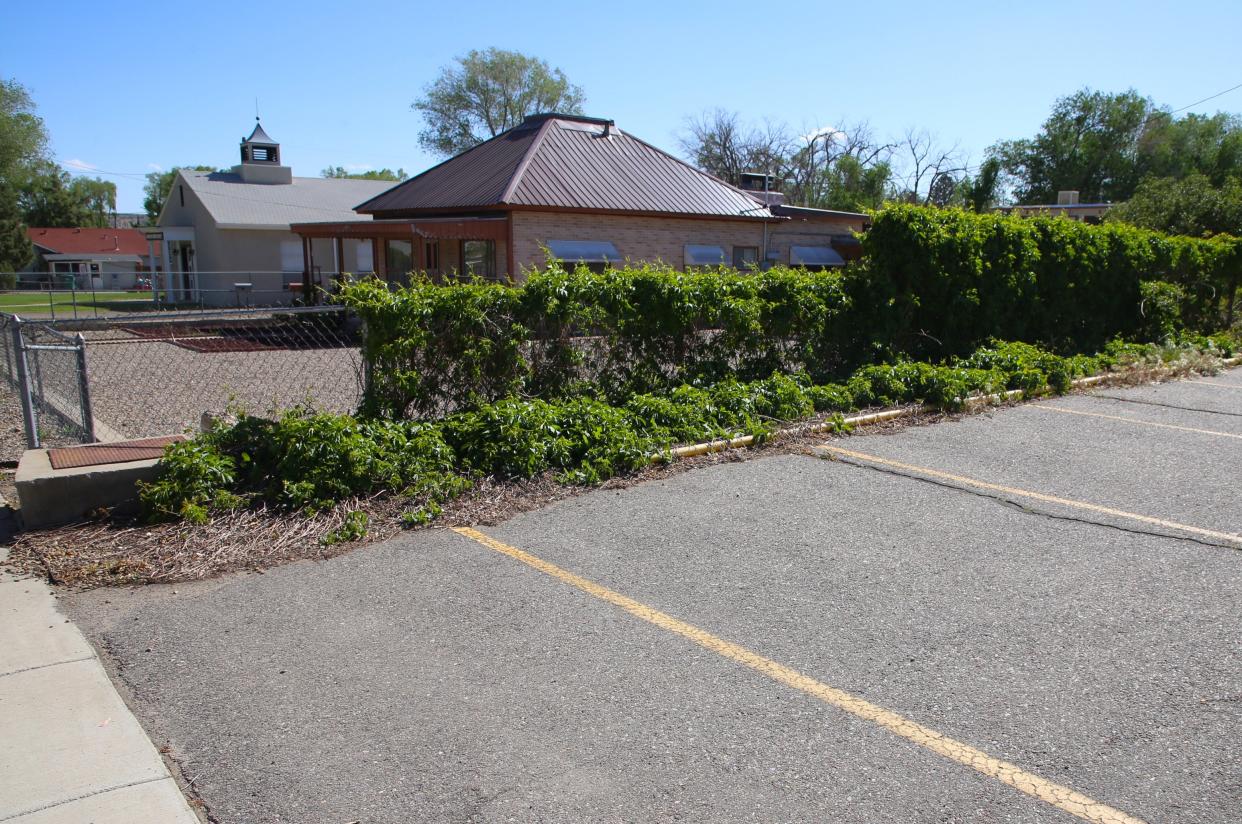 The parking lot of the First Presbyterian Church of Farmington is pictured where five Farmington police officers briefly huddled on the morning of May 15, 2023, before confronting a mass shooter just two doors down -- at the the building with a steeple on the left.