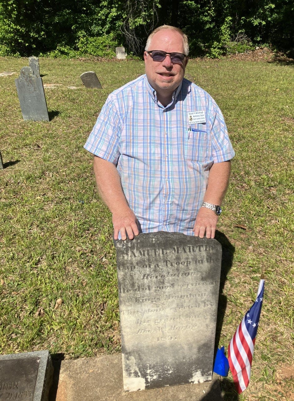 Russ McCullough stands at the recently marked grave of American Revolutionary War patriot Samuel Martin in Goshen Presbyterian Church Cemetery.
