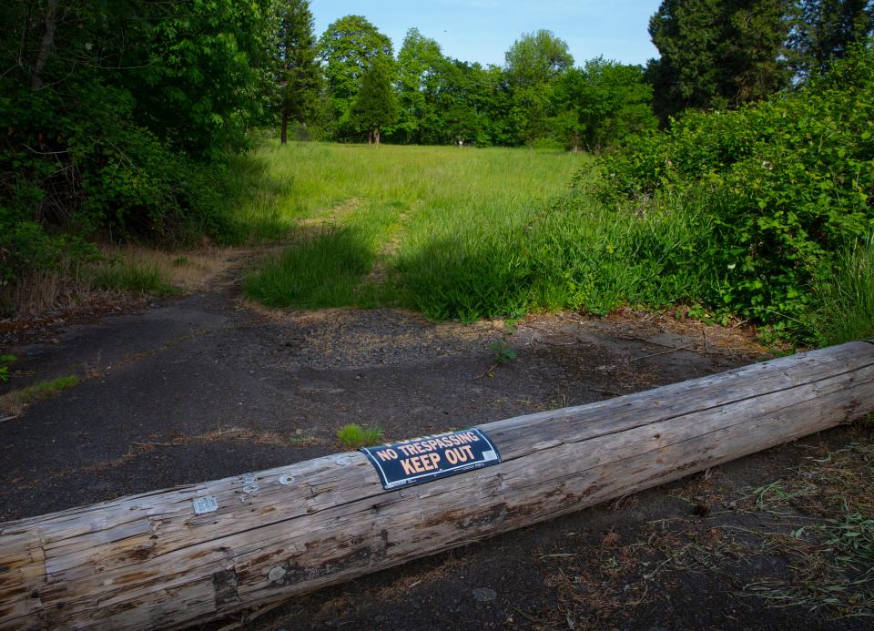 A sign and a log attempt to discourage visitors to a piece of City of Springfield owned property in Glenwood near the Willamette River that is being proposed for development.