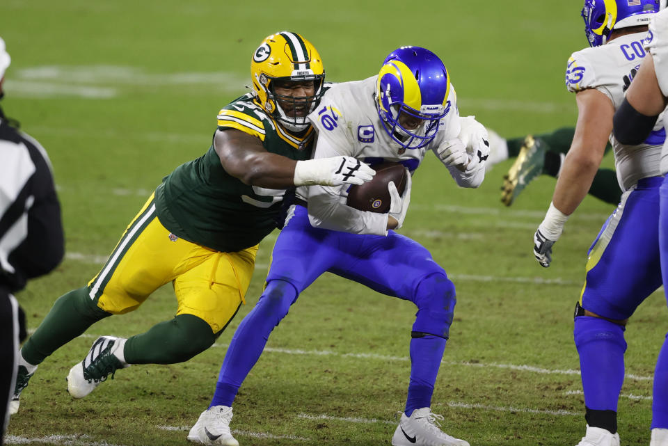 FILE - Green Bay Packers nose tackle Kenny Clark (97) sacks Los Angeles Rams quarterback Jared Goff (16) during an NFL divisional playoff football game Jan. 16, 2021, in Green Bay, Wis. The Packers should get an immediate indication of whether their defense is as stingy as its preseason billing suggests. (AP Photo/Jeffrey Phelps)