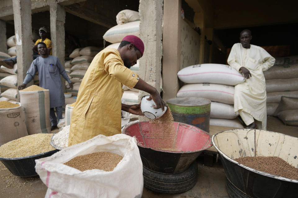 A man sells grain in Dawanau International Market in Kano Nigeria, Friday, July 14, 2023. Nigeria introduced programs before and during Russia's war in Ukraine to make Africa's largest economy self-reliant in wheat production. But climate fallout and insecurity in the northern part of the country where grains are largely grown has hindered the effort. (AP Photo/Sunday Alamba)