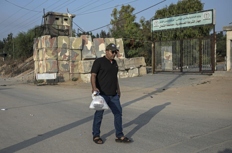 Palestinian Ibrahim Slaieh walks to the Erez crossing with Israel on his way to work in Beersheba, in Beit Hanoun northern Gaza Strip, Sunday, Aug 21, 2022. Since last year, Israel has issued over 15,000 permits allowing Palestinians from the Gaza Strip to work in Israel. Their wages are far higher than those available inside Gaza. With Gaza's economy in freefall, these permits are highly coveted and have given an important economic boost to thousands of families. But even Israel acknowledges the system is a powerful tool to preserve calm or — as critics say — control. (AP Photo/Fatima Shbair)