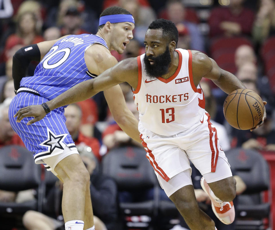 Houston Rockets guard James Harden (13) dribbles around Orlando Magic forward Aaron Gordon during the first half of an NBA basketball game, Sunday, Jan. 27, 2019, in Houston. (AP Photo/Eric Christian Smith)