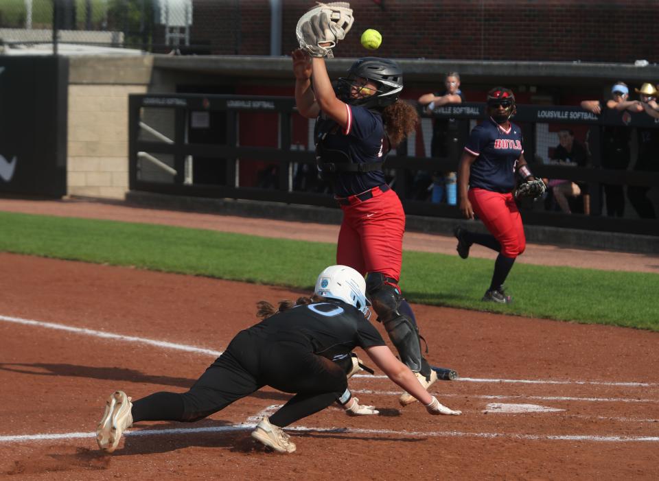Mercy’s Riley Clore scores against Butler’s Jenicca Alexander in the 6th Region Championship.May 23, 2023