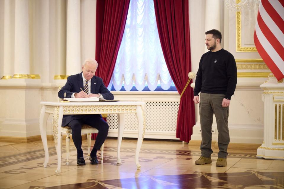 Joe Biden writing in the book of honoured guests during a meeting with Volodymyr Zelensky in Mariinsky Palace in Kyiv on February 20, 2023 (Ukrainian Presidential Press Service/AFP/via Getty Images)