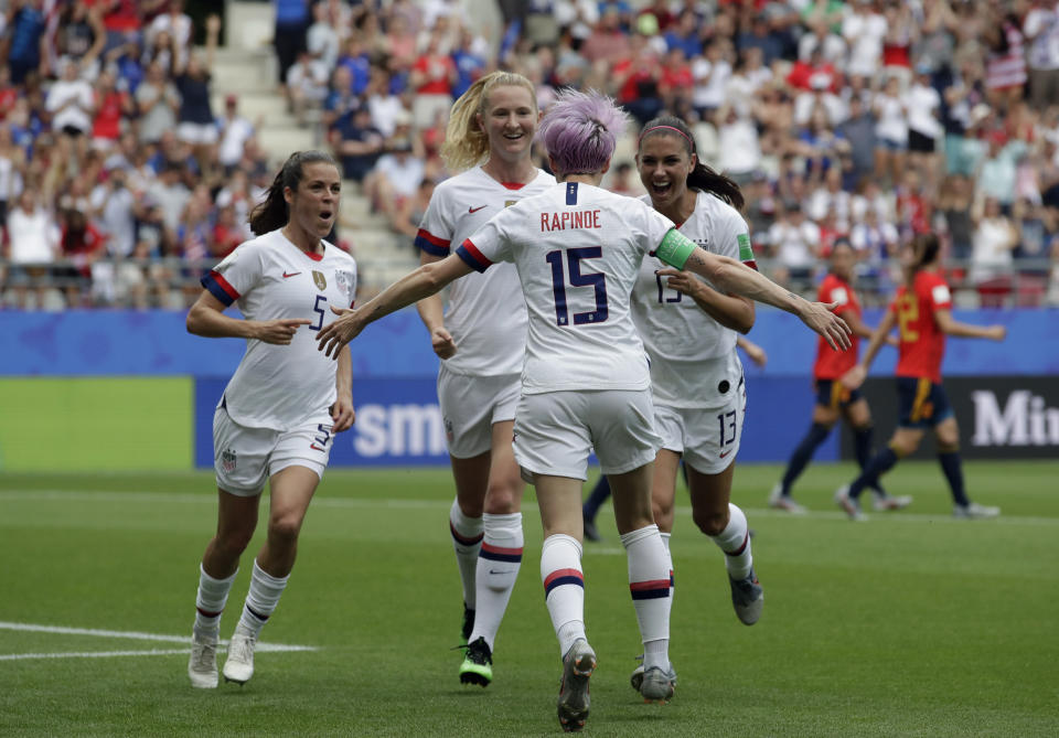 United States' Megan Rapinoe, front, celebrates with teammates after scoring the opening goal from a penalty spot during the Women's World Cup round of 16 soccer match between Spain and US at the Stade Auguste-Delaune in Reims, France, Monday, June 24, 2019. (AP Photo/Alessandra Tarantino)