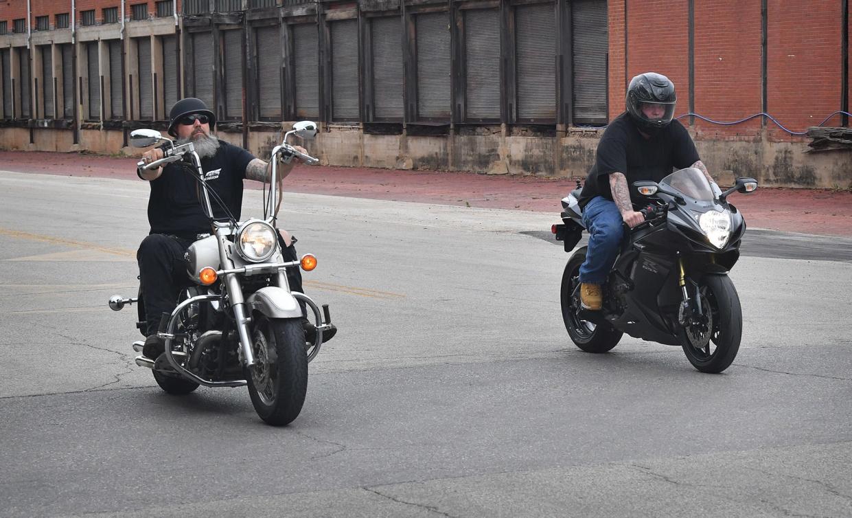 Josh Root, left, and Roy Tyler take a break from work at G&S Suzuki to ride around downtown. Motorists should be extra vigilant as more motorcyclists take to the streets in summer.