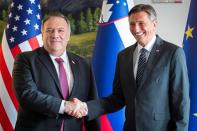Slovenia's President Borut Pahor, right, and US Secretary of State Mike Pompeo shake hands and pose for the media prior to their meeting in Bled, Slovenia, Thursday, Aug. 13, 2020. Pompeo is on a five-day visit to central Europe with a hefty agenda including China's role in 5G network construction. (Jure Makovec/Pool Photo via AP)