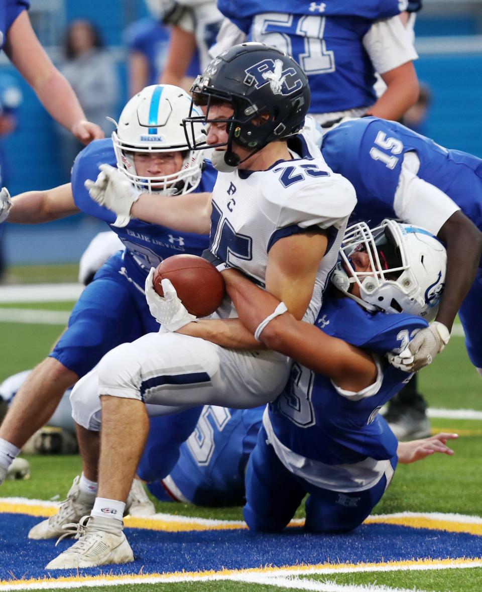 Haldane's Erik Stubblefield (33) tackles a Burke Catholic ball-carrier during the Class D state quarterfinal on Nov. 17, 2023.