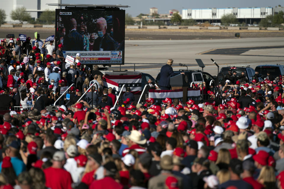 President Donald Trump plays a video of Democratic presidential candidate former Vice President Joe Biden during a campaign rally at Phoenix Goodyear Airport, Wednesday, Oct. 28, 2020, in Goodyear, Ariz. (AP Photo/Evan Vucci)