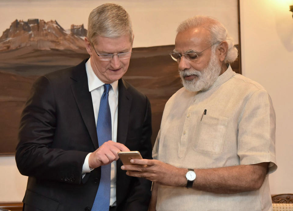 In this photo released by the Press Information Bureau of India, Indian Prime Minister Narendra Modi, right, meets Apple CEO Tim Cook, in New Delhi, India, Saturday, May 21, 2016. Apple CEO Tim Cook laid out his company's plans for the vast Indian market in a meeting Saturday with Prime Minister Narendra Modi, who in turn sought Apple's support for his 