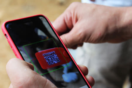 Circulor, a British start-up specialised in blockchain being used at the Gatumba mine, is pictured on a smartphone in Ngororero district, Western Rwanda October 17, 2018. REUTERS/Clement Uwiringiyimana