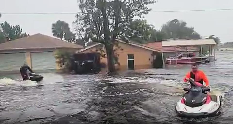 Jules De Ron on his personal watercraft heads down Wisconsin Street to rescue people