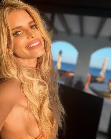 <p>Jessica Simpson/Instagram</p> Jessica Simpson shares a sunlit selfie in an orange bikini top