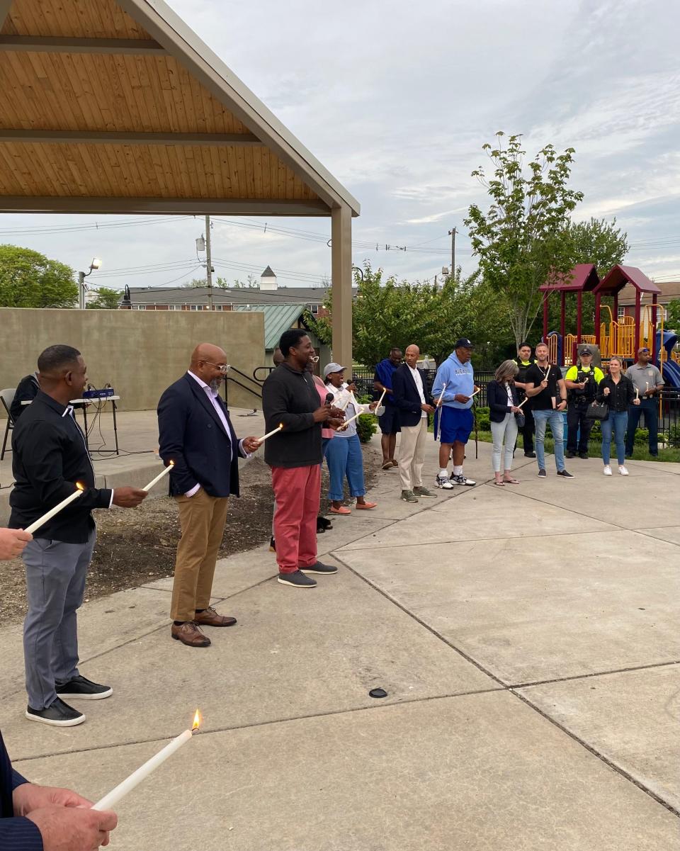 Religious leaders leading a candlelight vigil in Springwood Park for victims of gun violence on May 23.