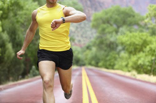 Man checking a fitness tracker on a run