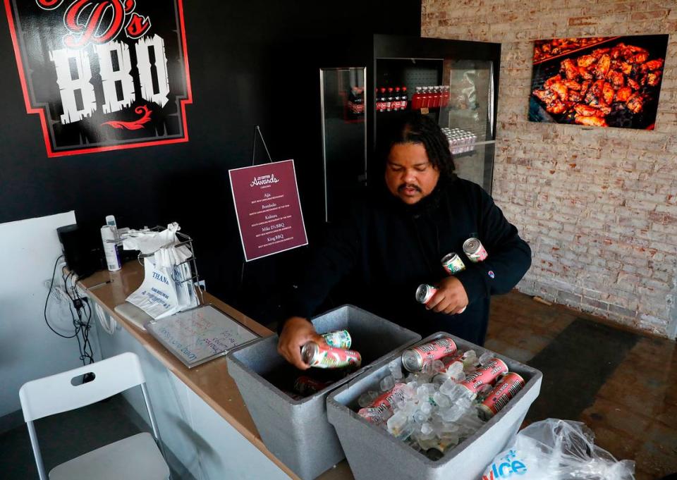 Mike De Los Santos, owner of Mike D’s BBQ, puts fruit sodas into coolers of ice as the business copes with a power outage on Thursday, Jan. 18, 2024, in Durham, N.C. The restaurant lost power on Wednesday afternoon due to an equipment failure during maintenance work at a substation. De Los Santos said he began work early Thursday morning to save the meat in his freezer. After making a post on social media, he says he received offers of help from restaurant and retail owners across the Triangle.