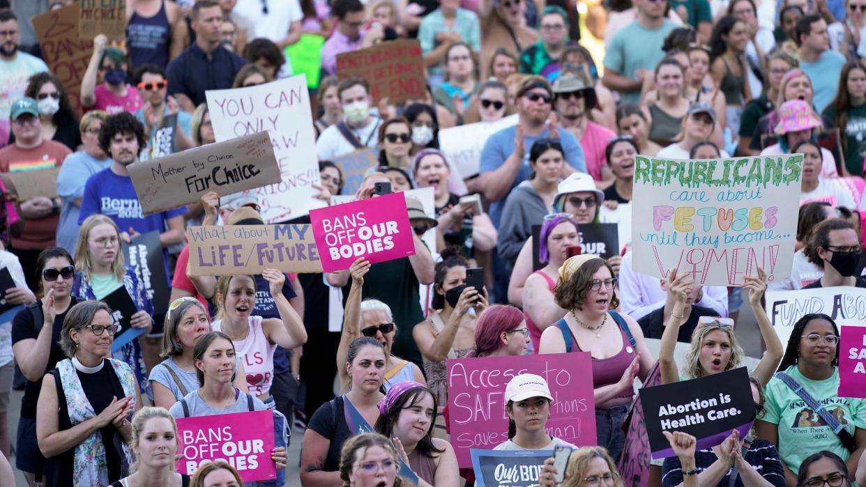 Abortion rights protesters attend a rally outside the state Capitol in Lansing, Mich., on June 24, 2022, following the United States Supreme Court's decision to overturn Roe v. Wade. 